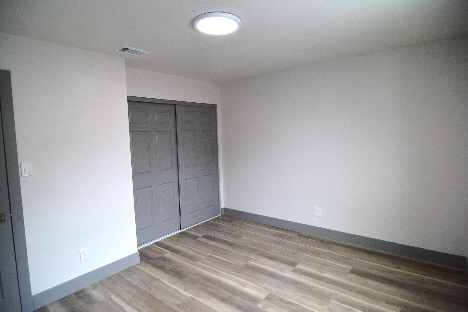 7536 Cosgrove Way Sacramento, CA 95822 - Photo 19 of 22 an empty room with wooden floor and windows