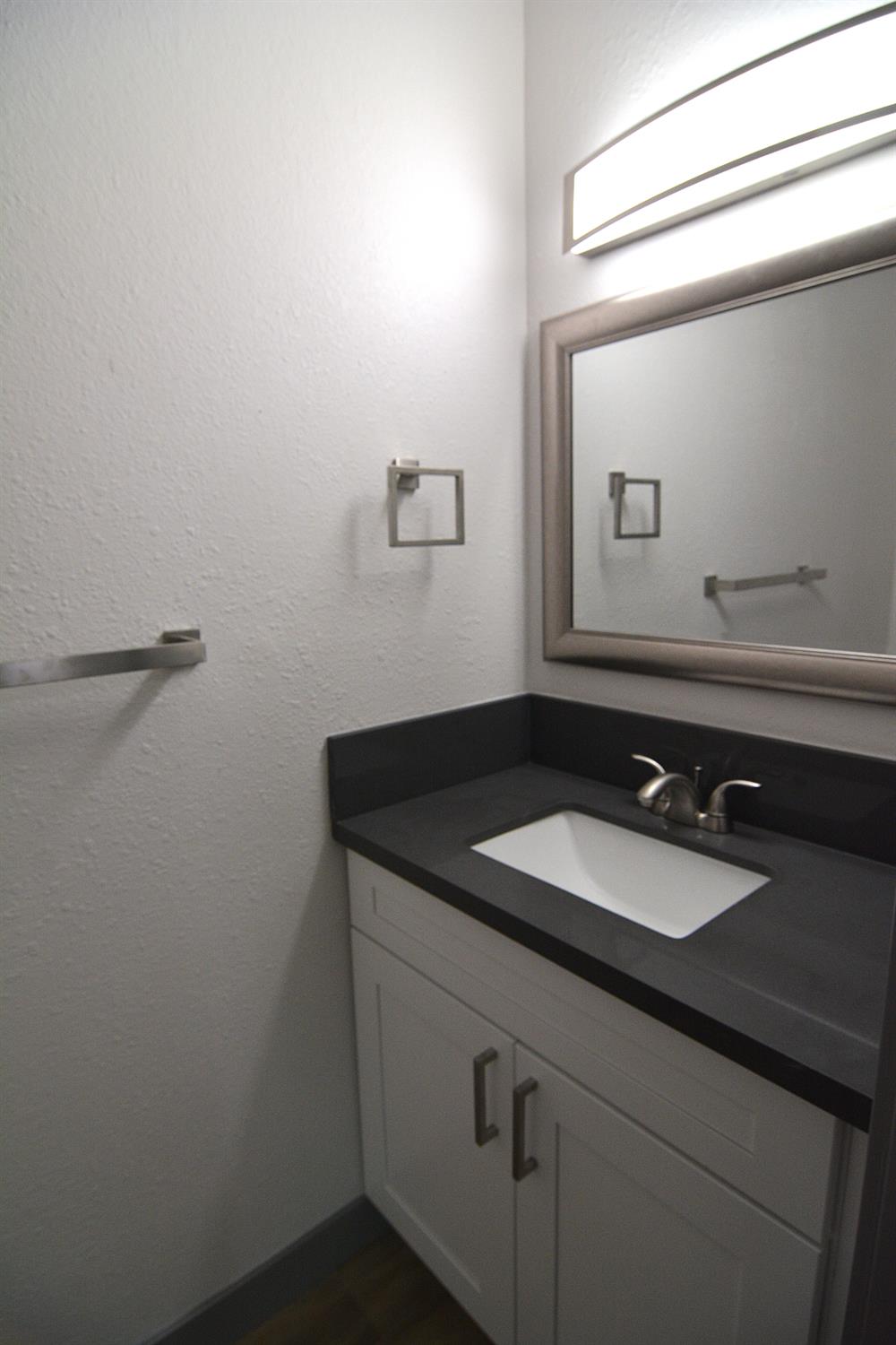 7536 Cosgrove Way Sacramento, CA 95822 - Photo 21 of 22 a bathroom with a granite countertop sink and a mirror