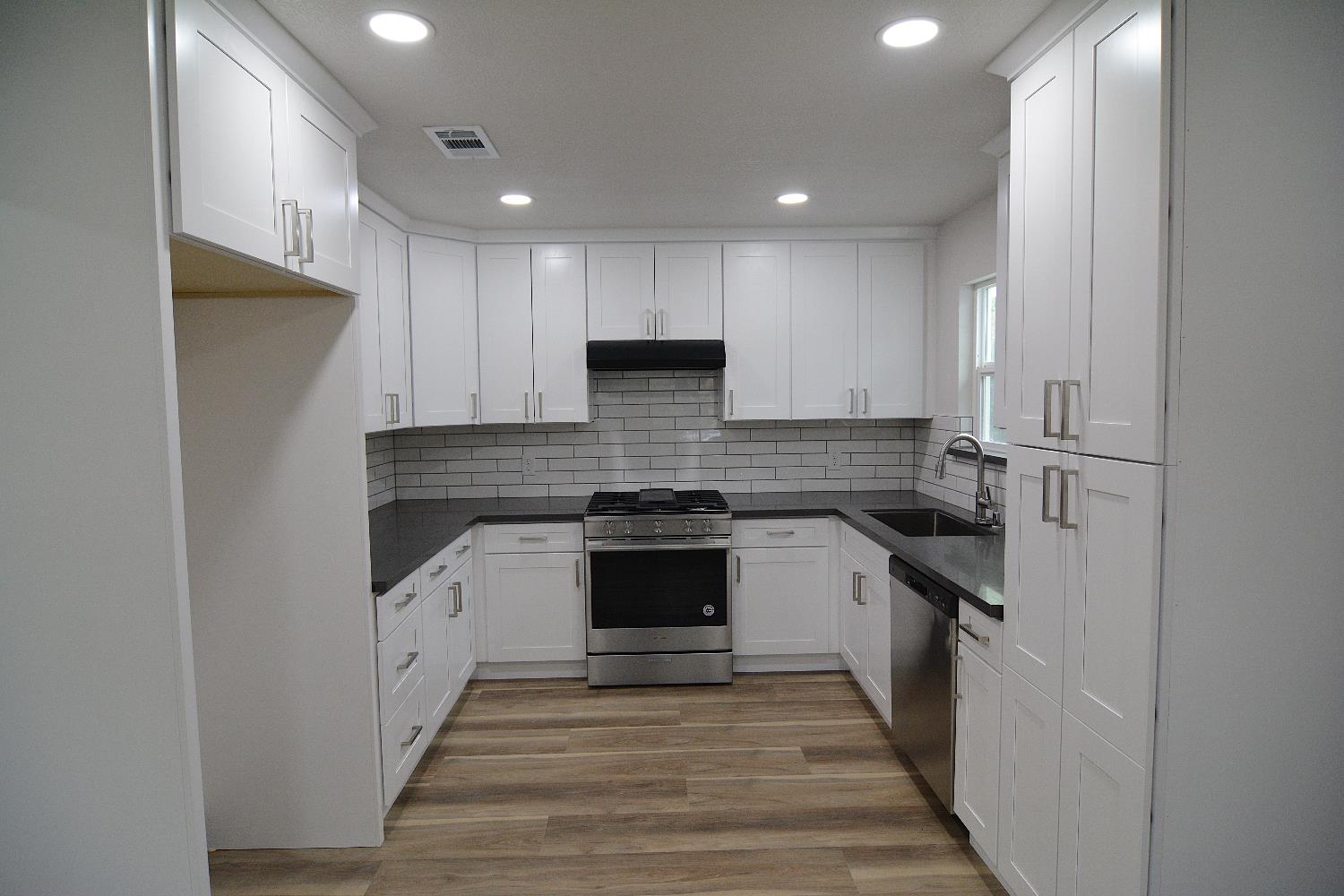 7536 Cosgrove Way Sacramento, CA 95822 - Photo 9 of 22 a kitchen with stainless steel appliances granite countertop a stove and a refrigerator