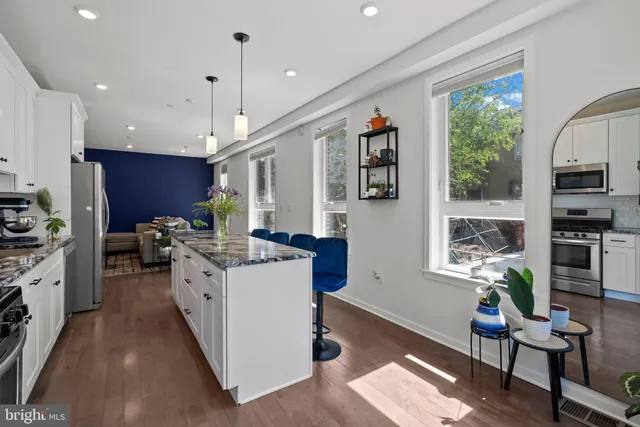 a living room with furniture a window and a flat screen tv