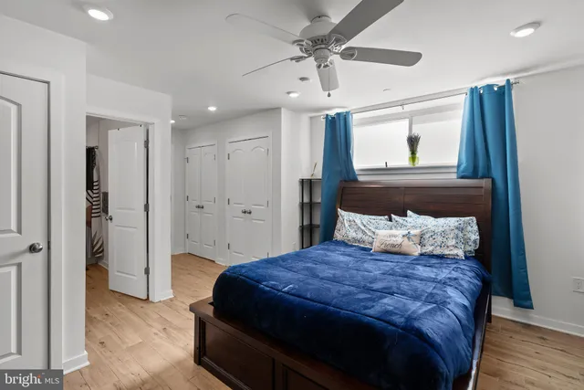 a bedroom with a large bed and a chandelier