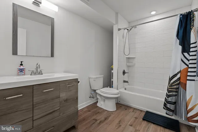 a bathroom with a sink toilet a mirror and shower