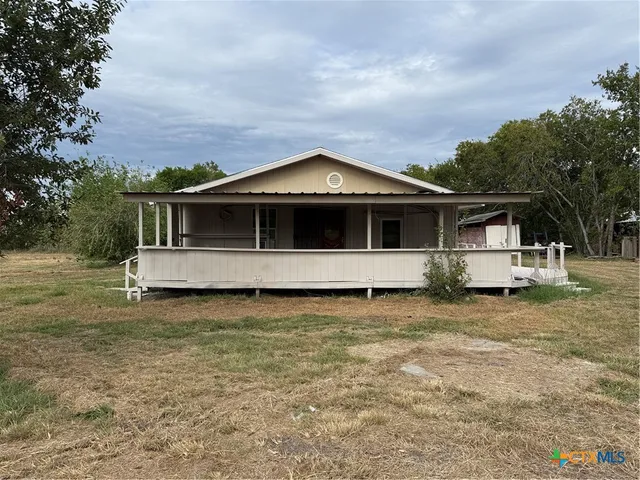 a view of a backyard with sitting area