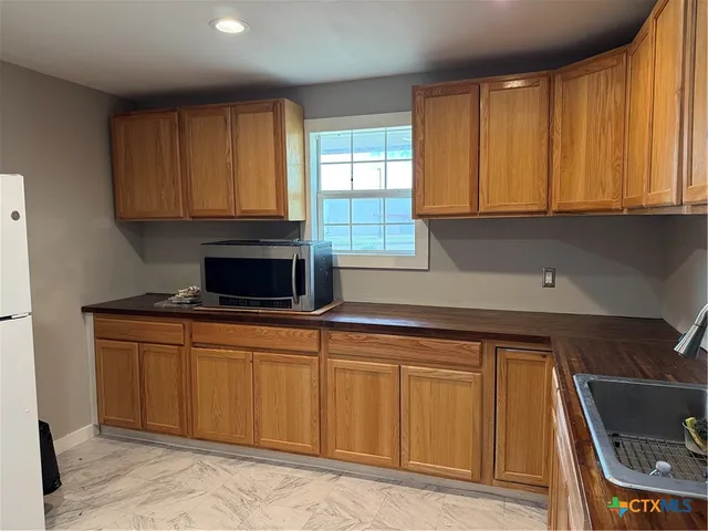 a kitchen with stainless steel appliances granite countertop a stove a sink and dishwasher