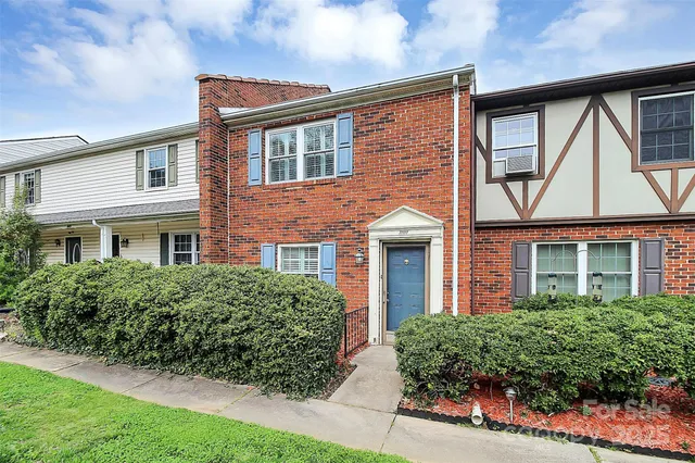 front view of a brick house with a large window