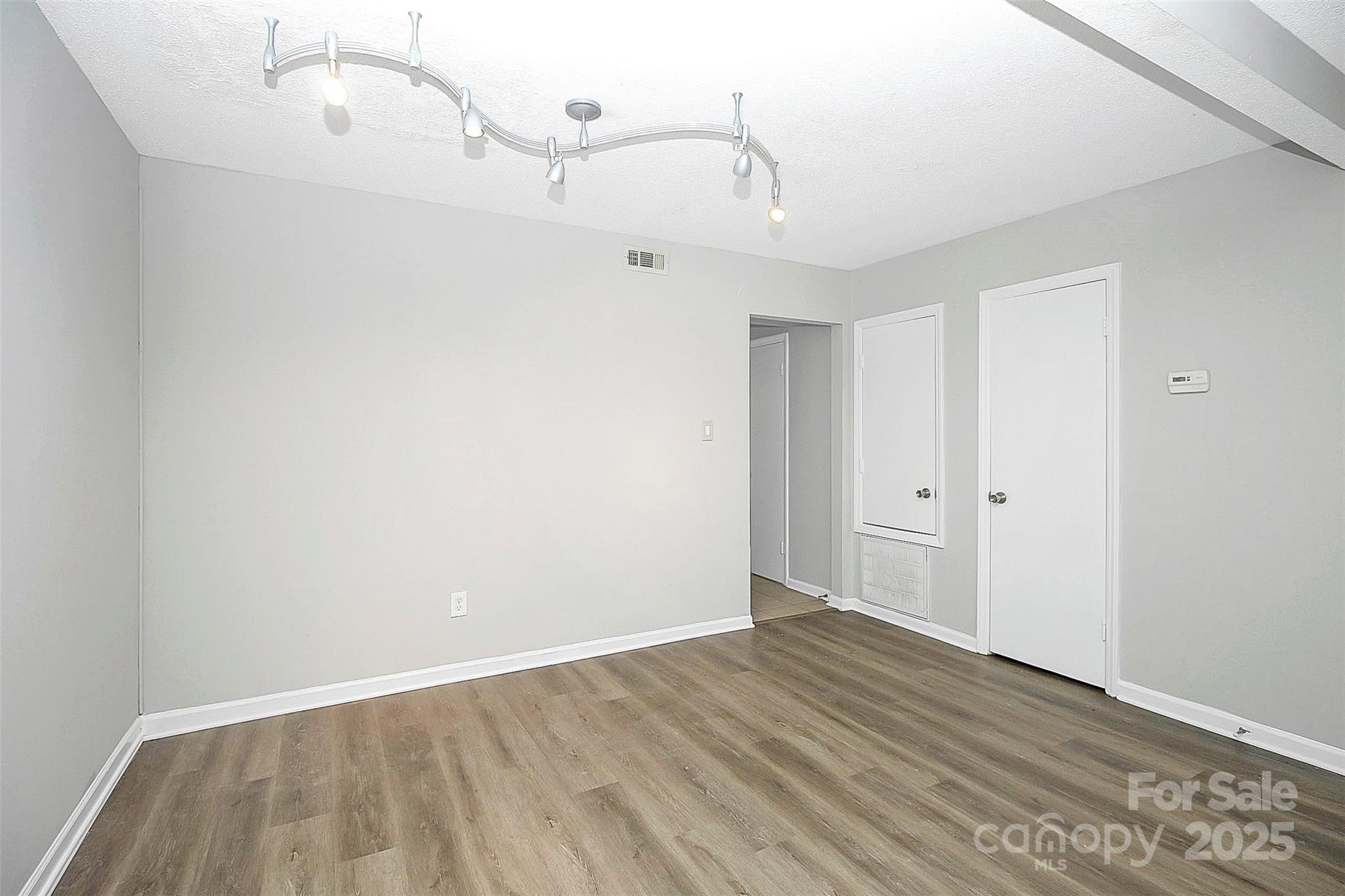 11111 Park Road Charlotte, NC 28226 - Photo 6 of 20 a view of a room with wooden floor and white walls