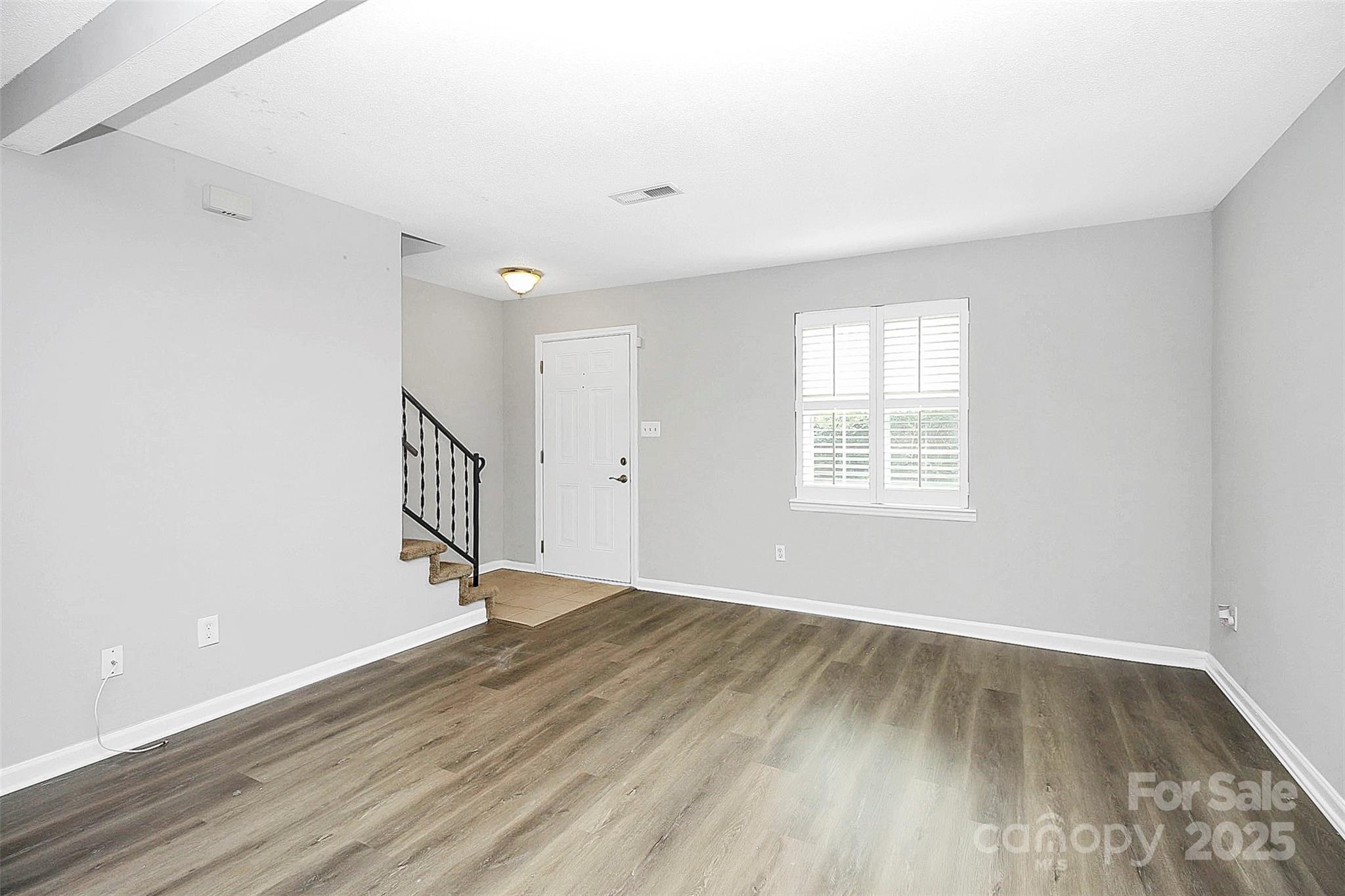 11111 Park Road Charlotte, NC 28226 - Photo 8 of 20 an empty room with wooden floor and windows
