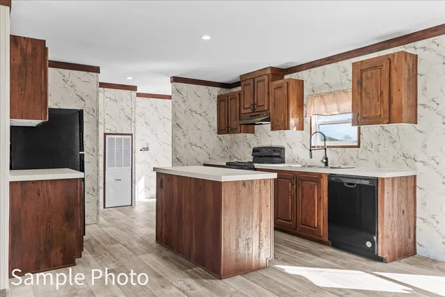 a view of an empty room with a fireplace and a window