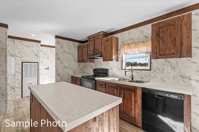 a kitchen with stainless steel appliances granite countertop a stove sink and cabinets