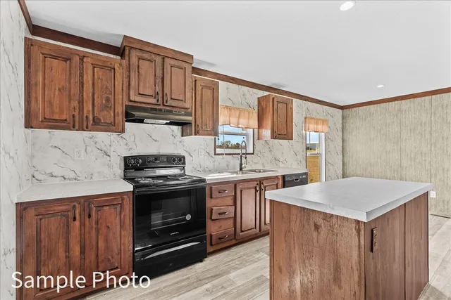 a kitchen with stainless steel appliances granite countertop a refrigerator a stove and a wooden floors