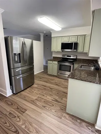 a kitchen with kitchen island a sink and refrigerator