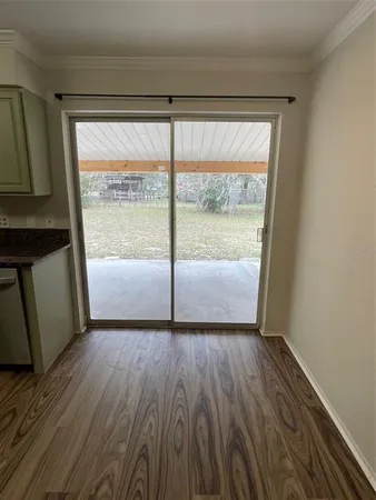 a view of a room with wooden floor and doors
