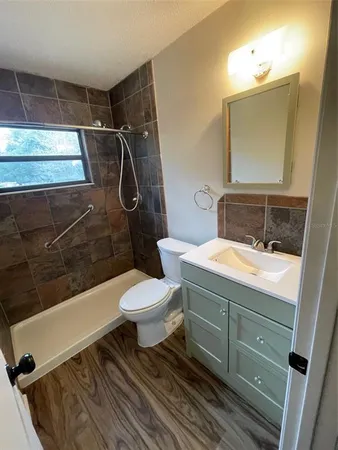 a bathroom with a sink toilet and shower