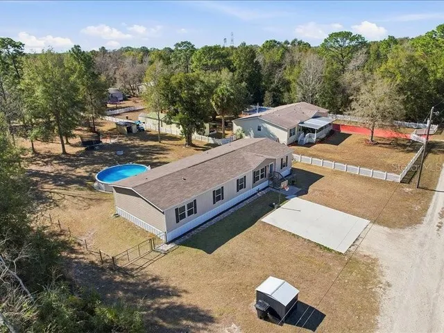 an aerial view of a house with a yard