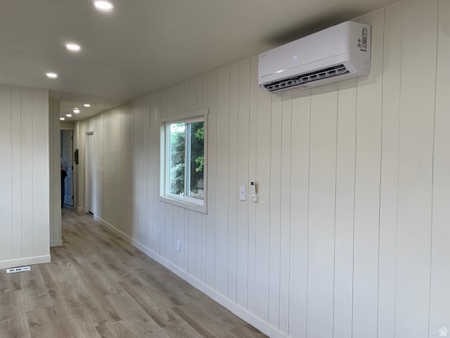 1500 North Angel Street West, Unit 56 Layton, UT 84041 - Photo 7 of 20 Interior space featuring light wood-finish flooring, white vertical plank walls, recessed ceiling lighting, and a wall-mounted mini-split system