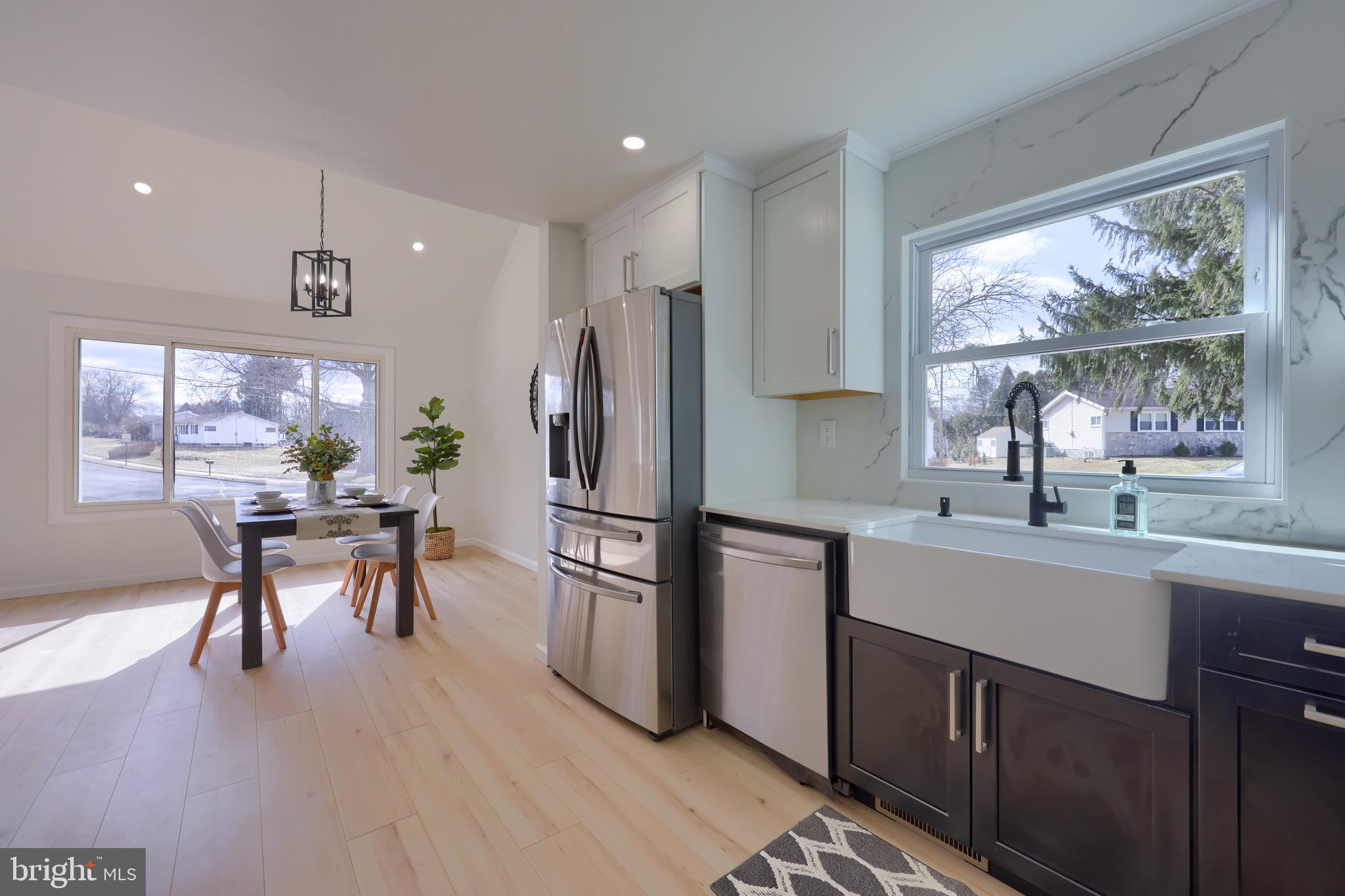 2709 Chapel Road Lancaster, PA 17603 - Photo 22 of 67 a kitchen with a refrigerator a sink white cabinets and wooden floors