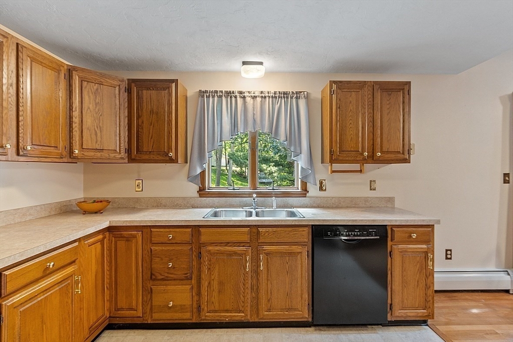 58 Peabody Road, Unit B Shirley, MA 01464 - Photo 15 of 38 a kitchen with stainless steel appliances granite countertop a sink a stove a refrigerator and cabinets