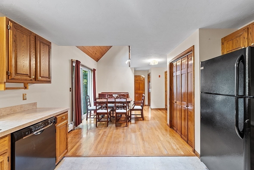 58 Peabody Road, Unit B Shirley, MA 01464 - Photo 18 of 38 a kitchen with stainless steel appliances granite countertop a refrigerator microwave and wooden floor