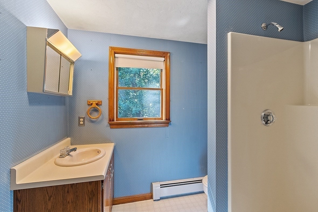 58 Peabody Road, Unit B Shirley, MA 01464 - Photo 22 of 38 a bathroom with a sink a toilet and a window
