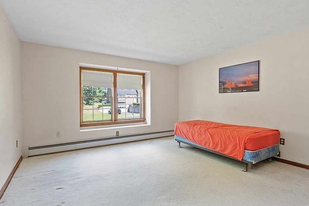 58 Peabody Road, Unit B Shirley, MA 01464 - Photo 23 of 38 a room with a bed and a couch in it