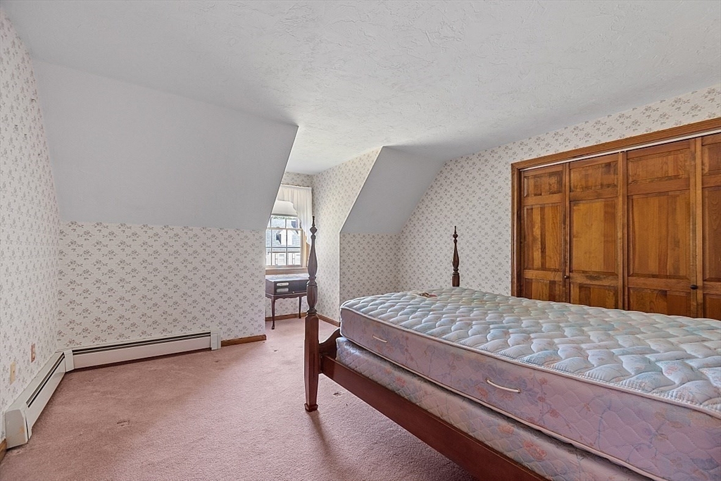 58 Peabody Road, Unit B Shirley, MA 01464 - Photo 31 of 38 a bedroom with a bed and a dresser