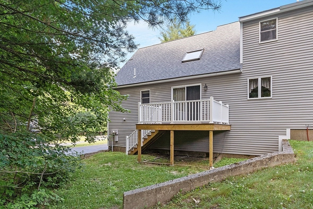 58 Peabody Road, Unit B Shirley, MA 01464 - Photo 34 of 38 a backyard of a house with table and chairs