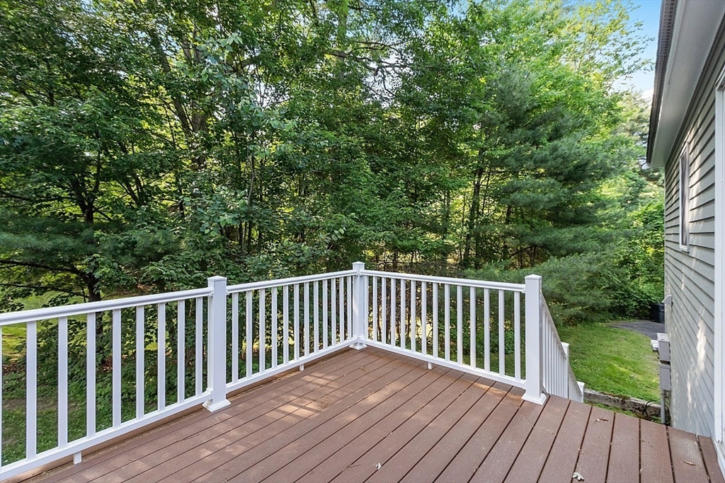 58 Peabody Road, Unit B Shirley, MA 01464 - Photo 37 of 38 a wooden deck with trees in front of it