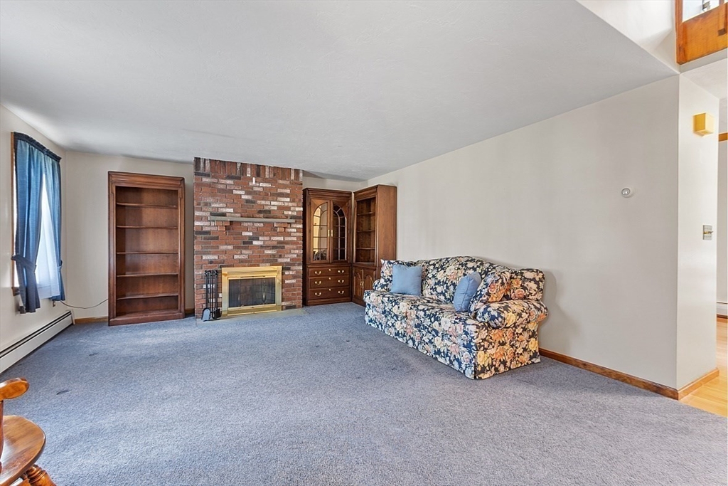 58 Peabody Road, Unit B Shirley, MA 01464 - Photo 8 of 38 an empty room with furniture and a fireplace