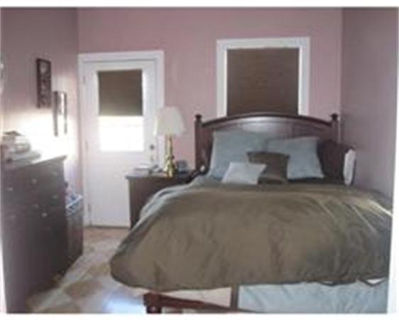 346 West 3rd Street, Unit 21 Boston, MA 02127 - Photo 8 of 11 a bedroom with a bed and a mirror