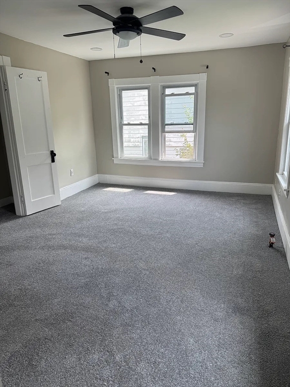 36 Sunapee Street Springfield, MA 01108 - Photo 14 of 18 an empty room with windows and ceiling fan