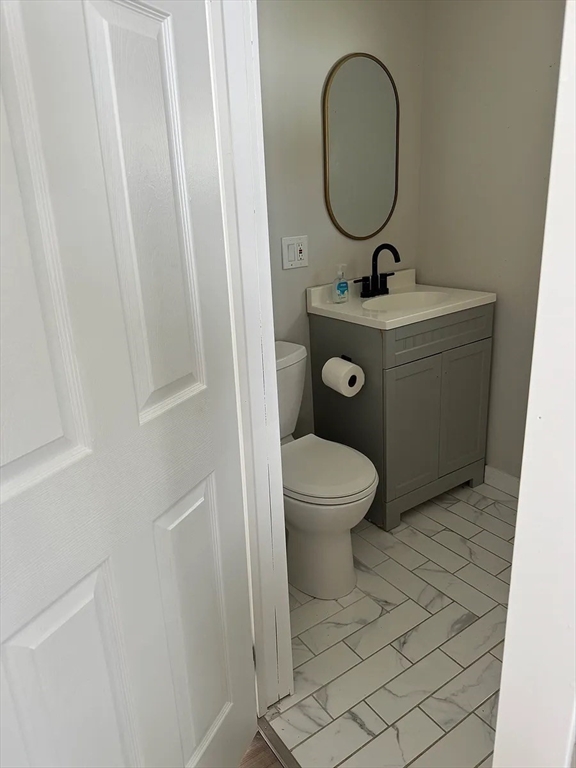 36 Sunapee Street Springfield, MA 01108 - Photo 7 of 18 a bathroom with a toilet a sink and a mirror