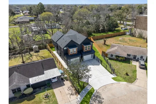 an aerial view of a house with a yard swimming pool