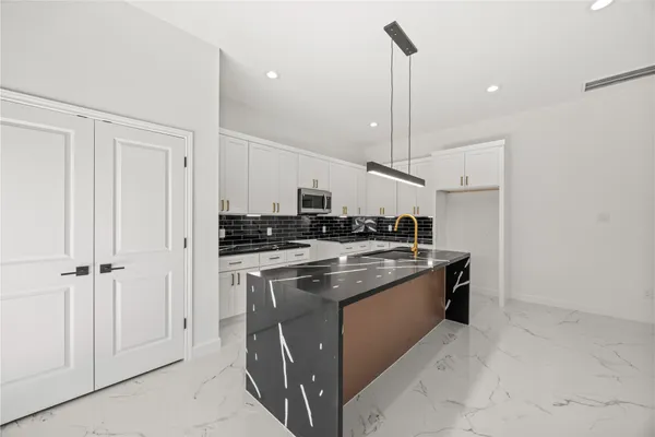 a kitchen with stainless steel appliances granite countertop a stove and a sink
