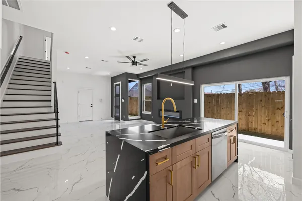 a kitchen that has a sink a stove and a wooden floor