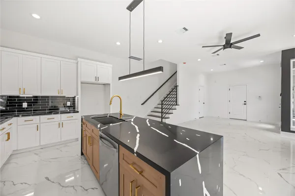 a kitchen that has a sink and a stove in it