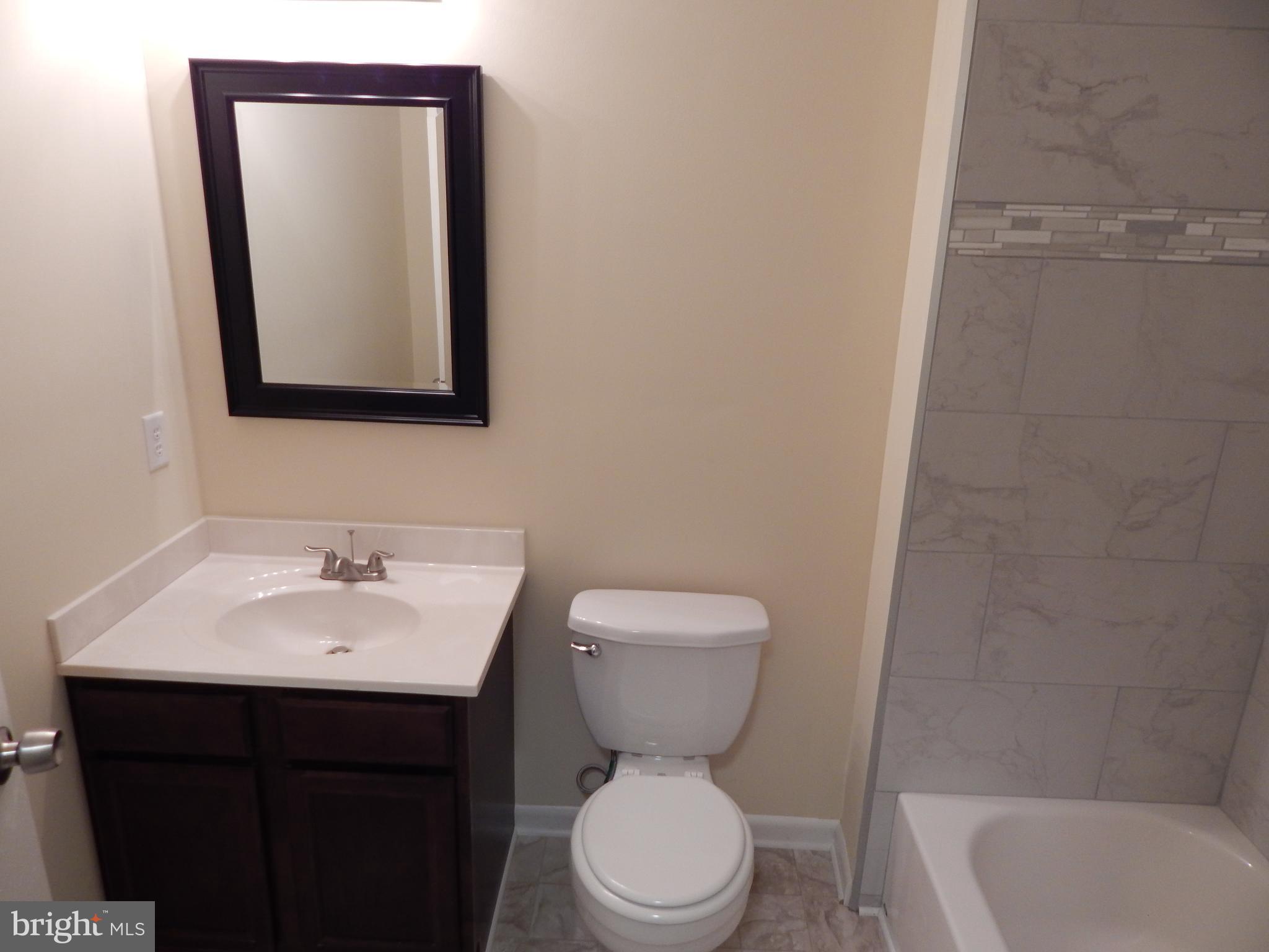 138 Lemon Road Ranson, WV 25438 - Photo 12 of 29 a bathroom with a toilet sink and mirror