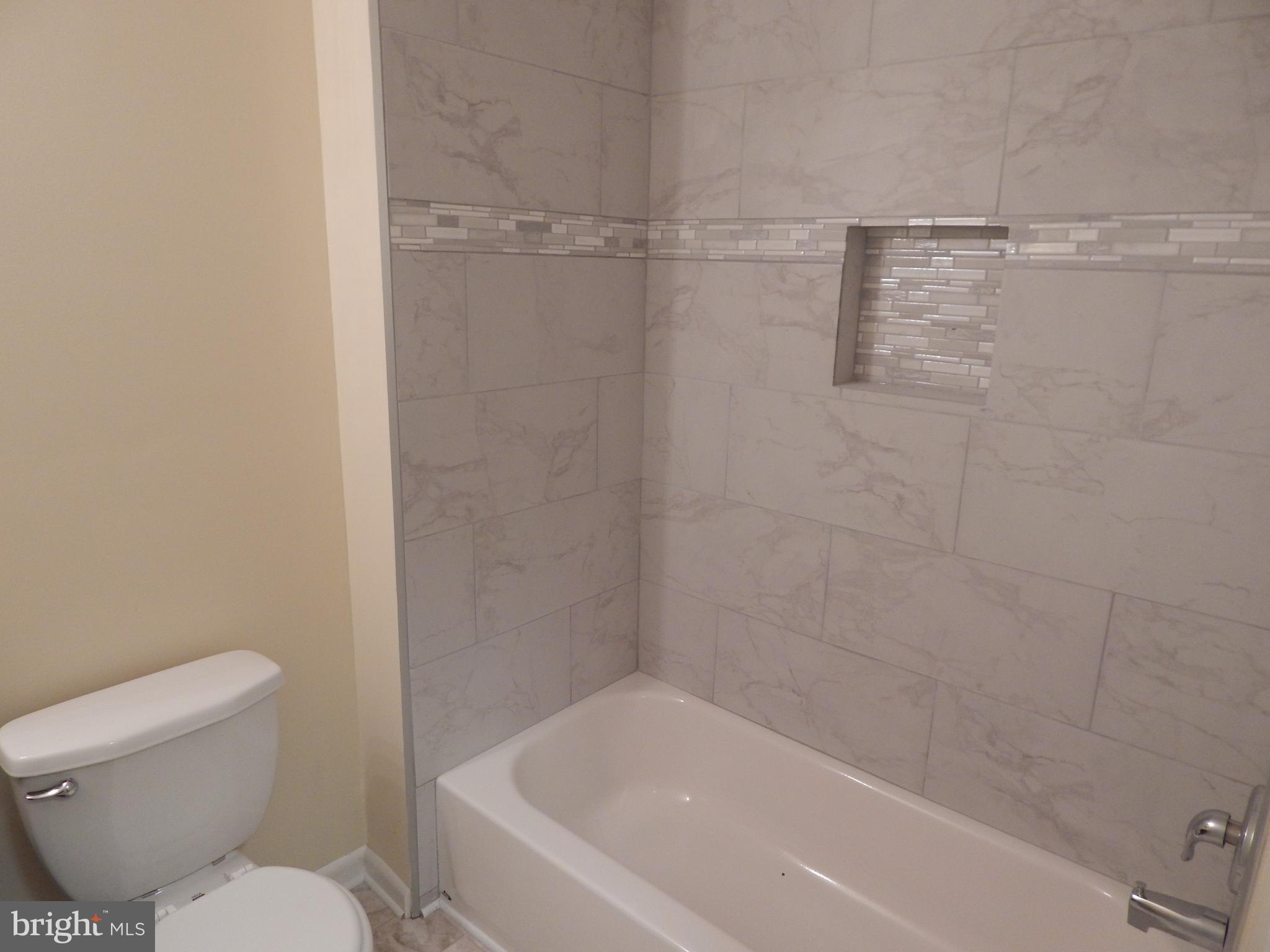 138 Lemon Road Ranson, WV 25438 - Photo 15 of 29 a white bath tub sitting next to a toilet