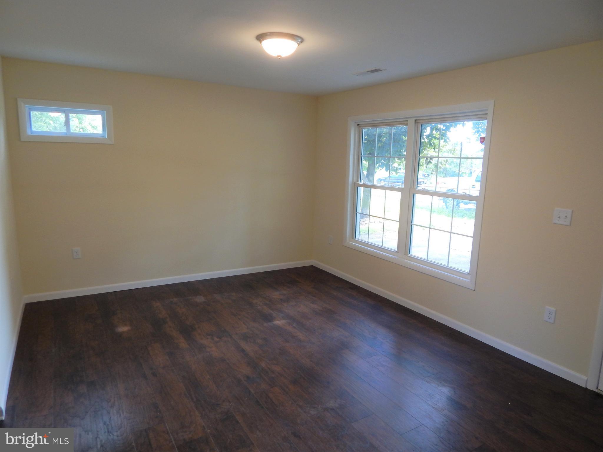 138 Lemon Road Ranson, WV 25438 - Photo 3 of 29 an empty room with wooden floor and windows