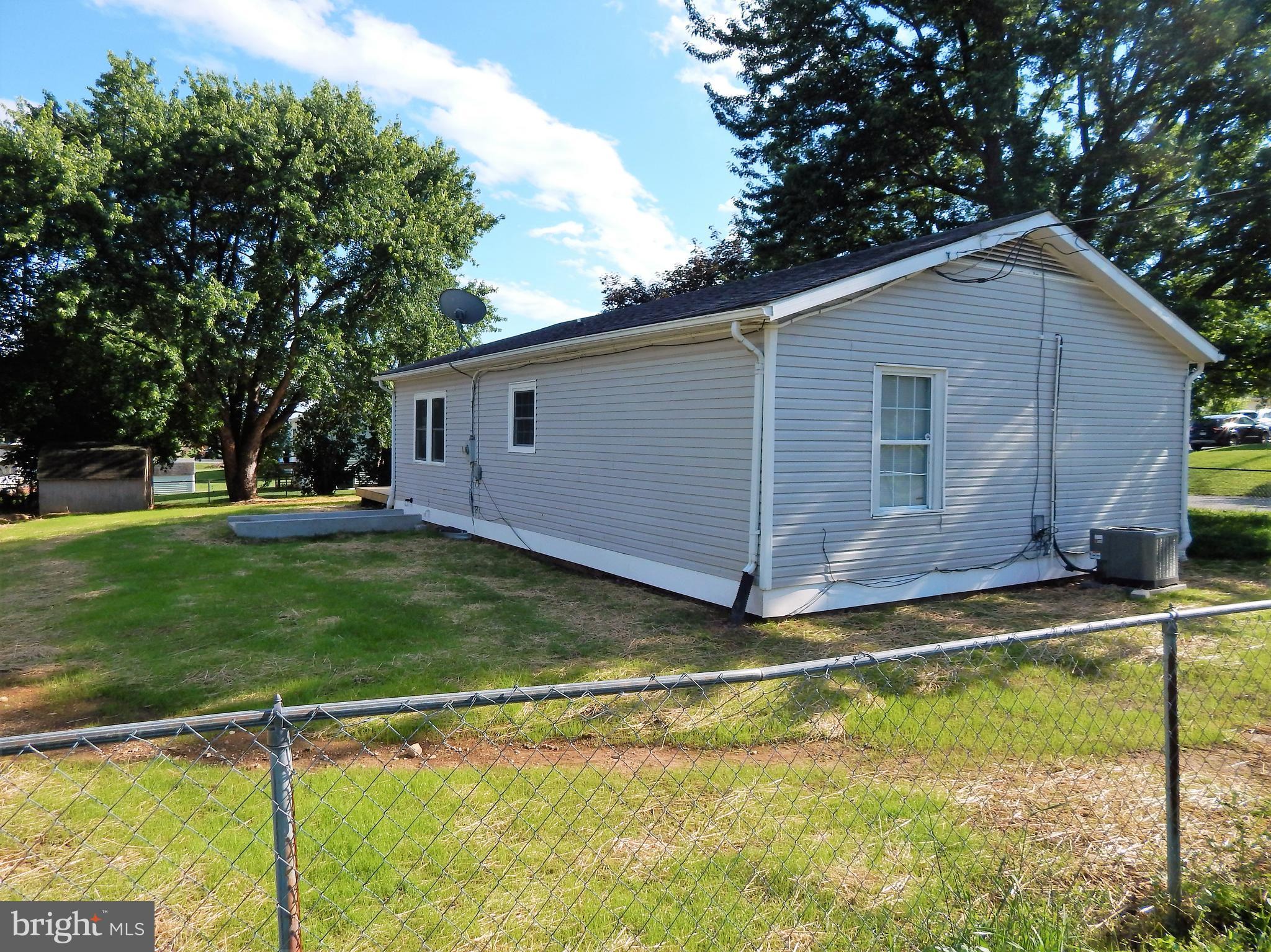 138 Lemon Road Ranson, WV 25438 - Photo 26 of 29 a backyard of a house with swimming pool and big trees