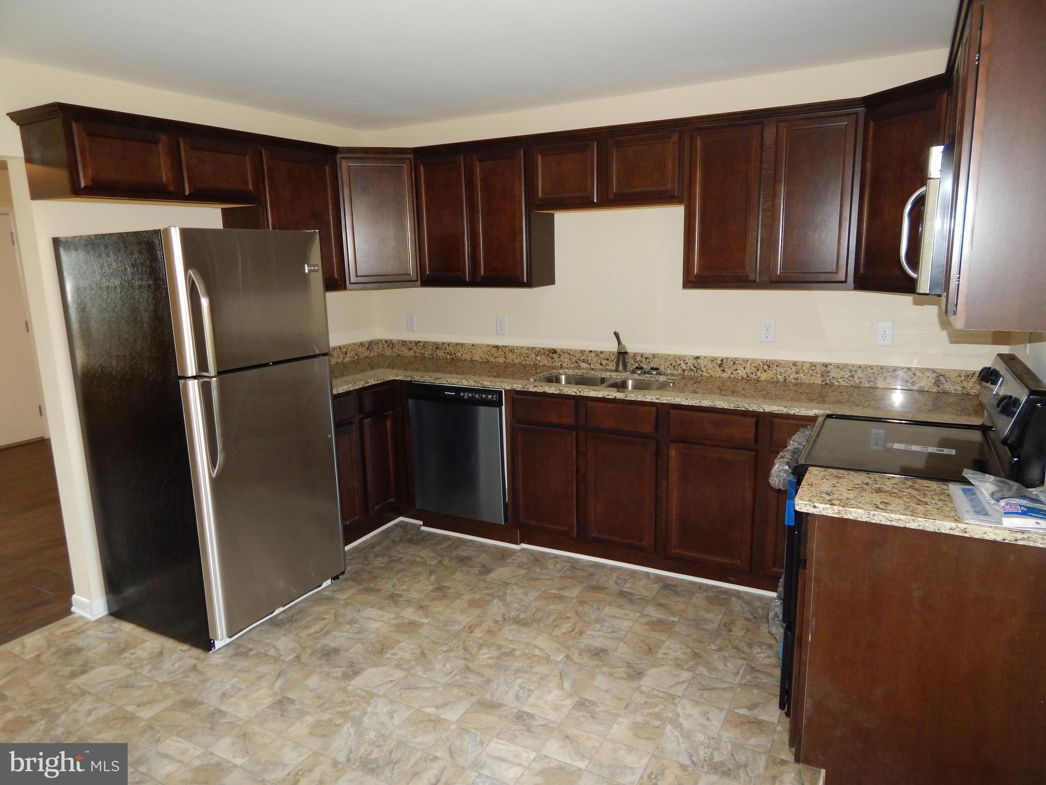 138 Lemon Road Ranson, WV 25438 - Photo 8 of 29 a kitchen with stainless steel appliances granite countertop a refrigerator stove and sink