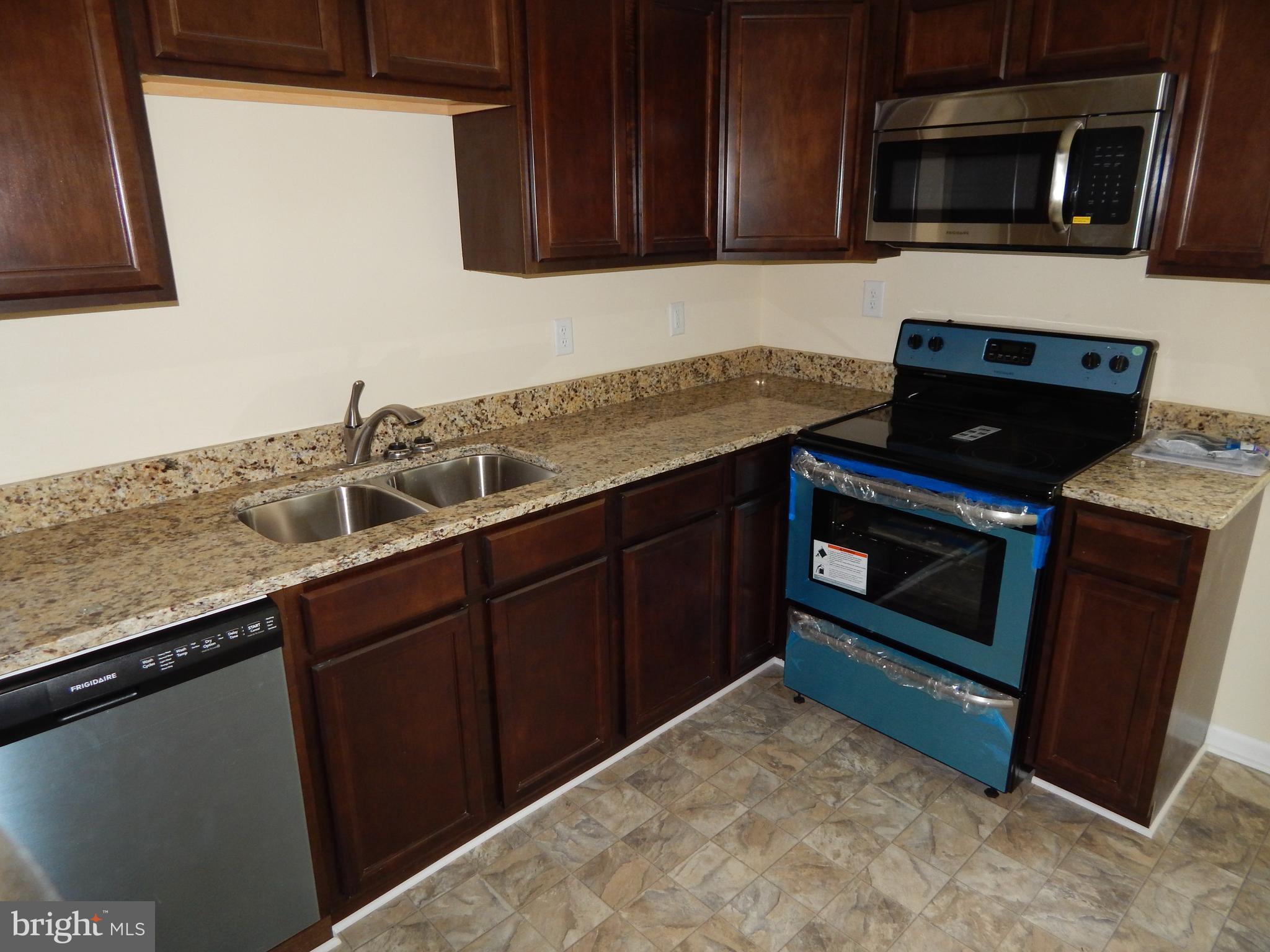138 Lemon Road Ranson, WV 25438 - Photo 9 of 29 a kitchen with a sink stove and microwave