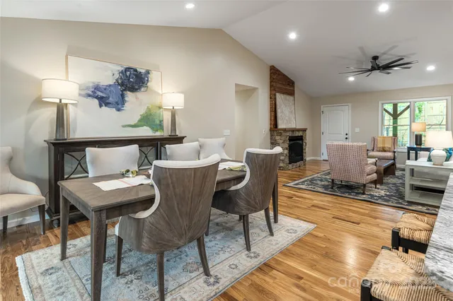 a spacious bathroom with a granite countertop sink a mirror and a shower
