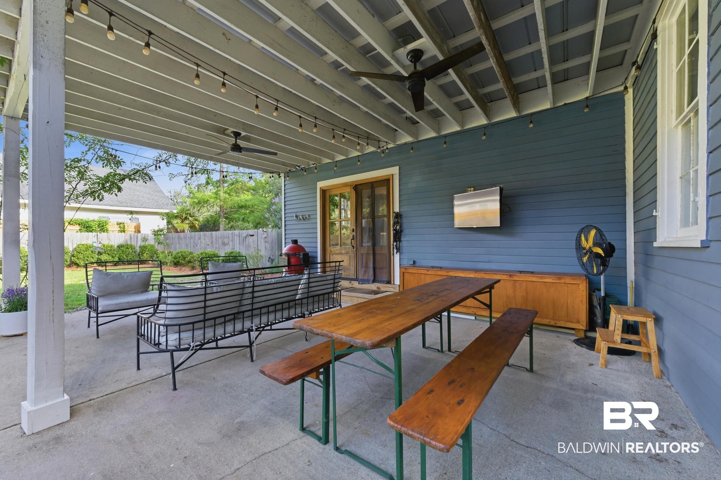 350 Charles Street Mobile, AL 36604 - Photo 32 of 52 Expansive covered patio featuring a concrete surface, exposed beam ceiling, string lighting, and two ceiling fans