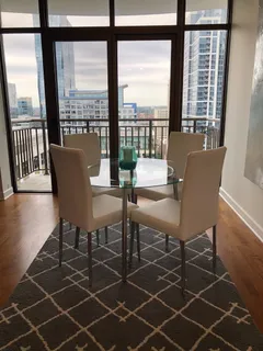 a dining room with furniture and wooden floor