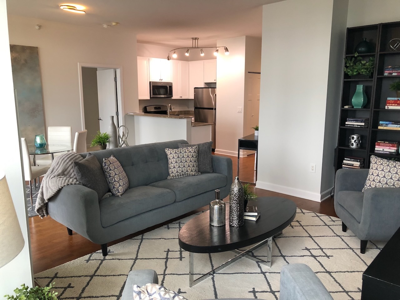 233 East 13th Street, Unit 2210 Chicago, IL 60605 - Photo 9 of 28 a living room with furniture and a dining table with kitchen view