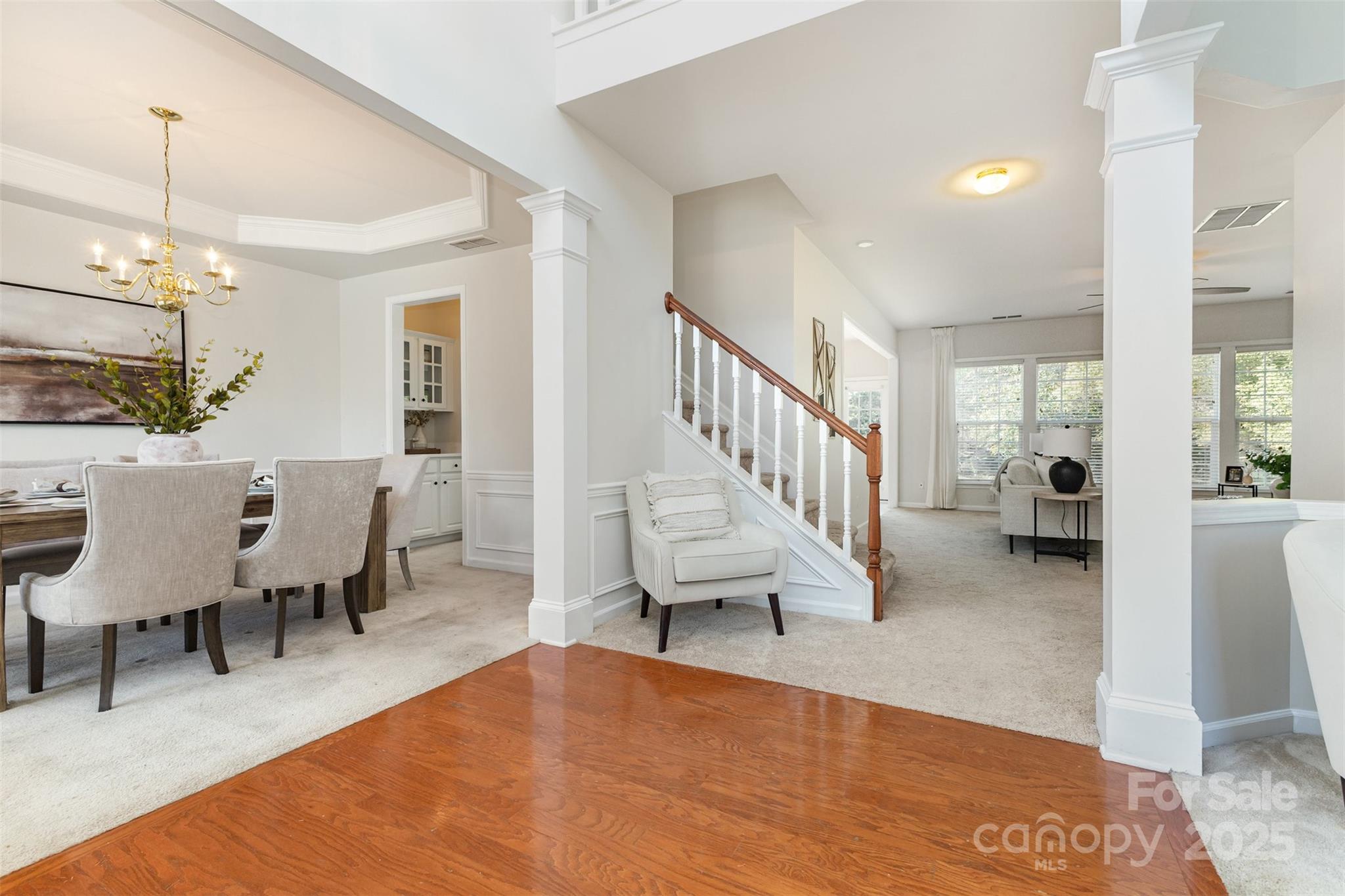 7633 Rathburn Lane Charlotte, NC 28277 - Photo 14 of 27 a living room with couches and a dining table with wooden floor