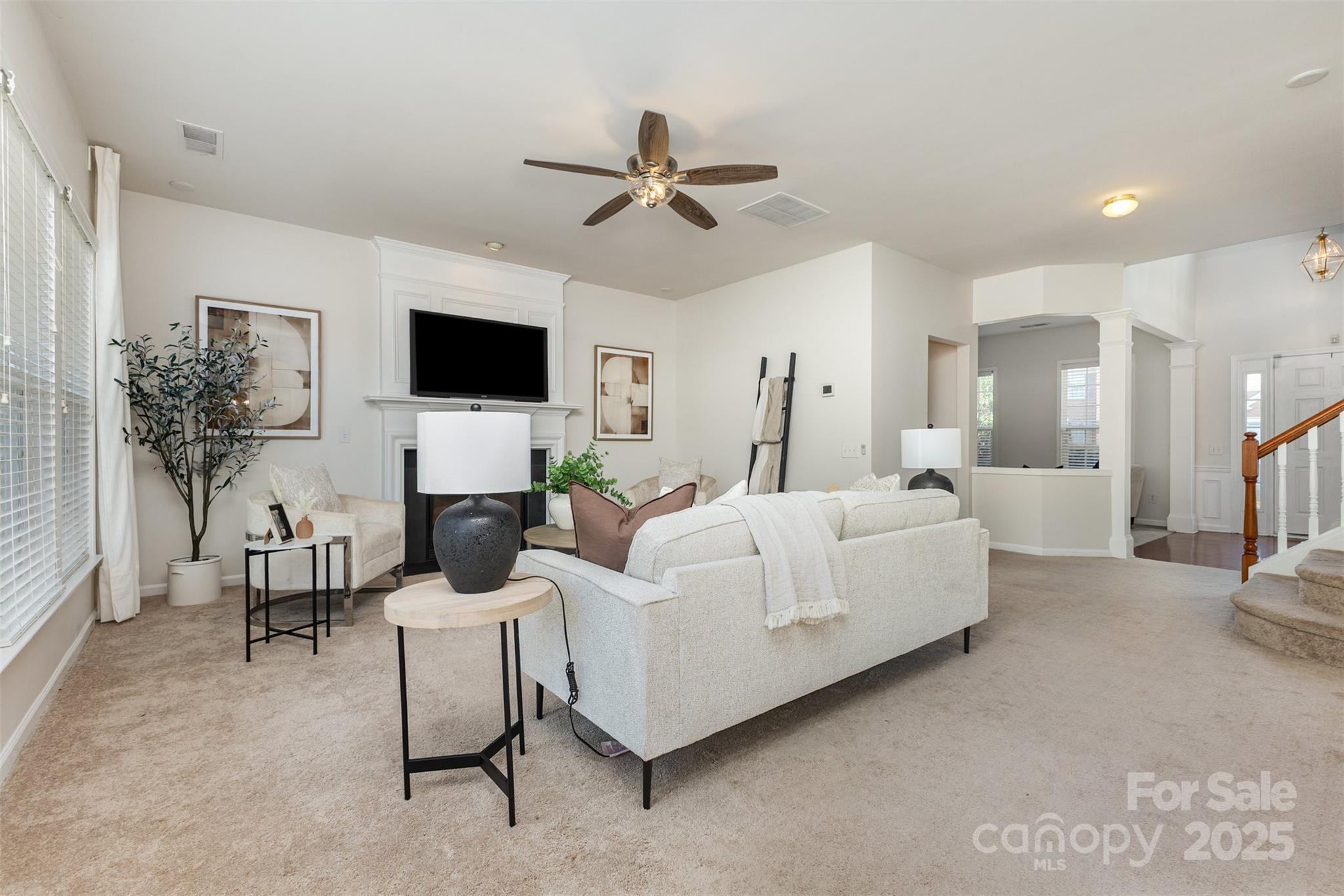 7633 Rathburn Lane Charlotte, NC 28277 - Photo 19 of 27 a living room with furniture a flat screen tv and a fireplace