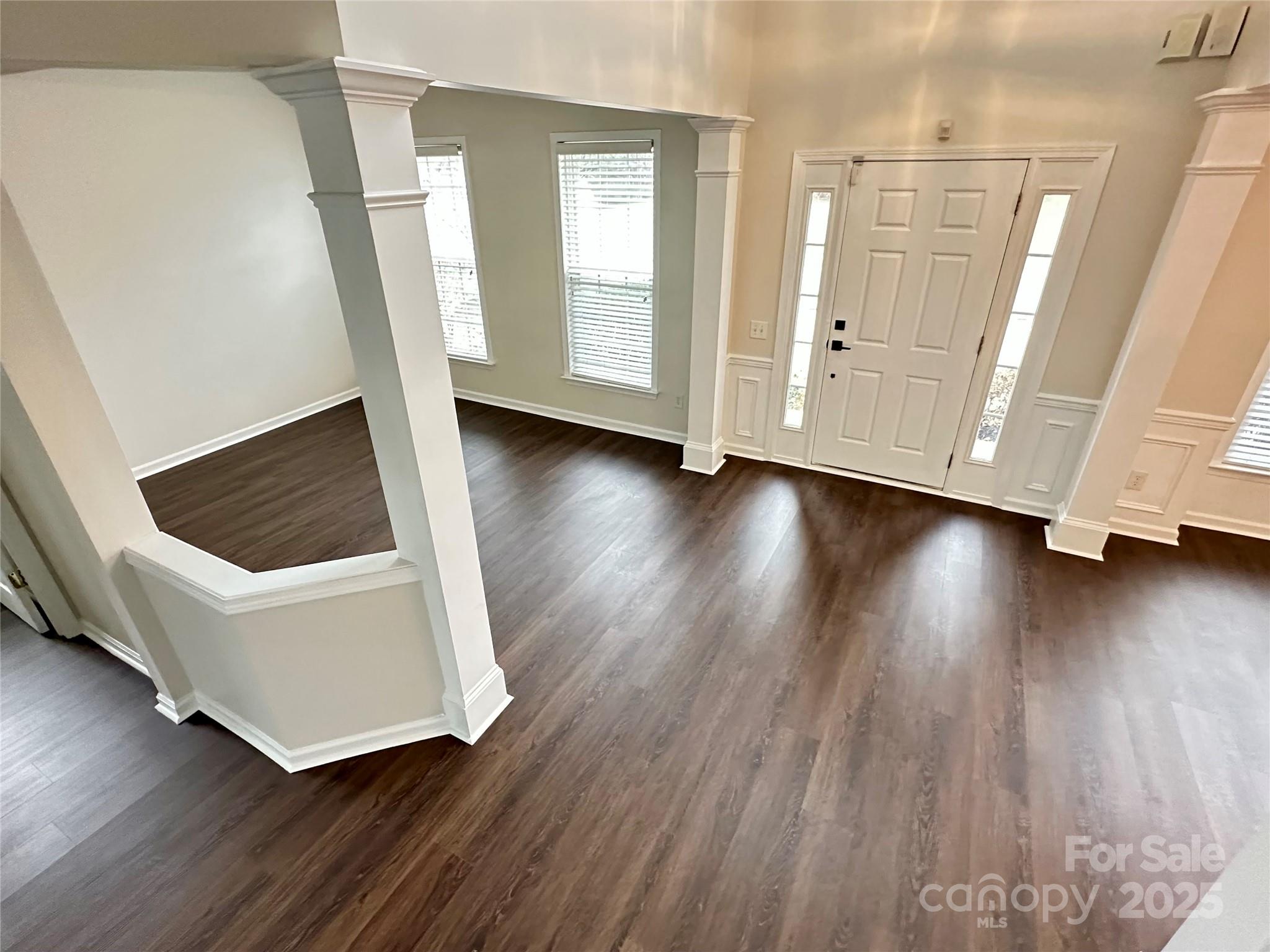 7633 Rathburn Lane Charlotte, NC 28277 - Photo 2 of 27 a view of an empty room with wooden floor and stairs