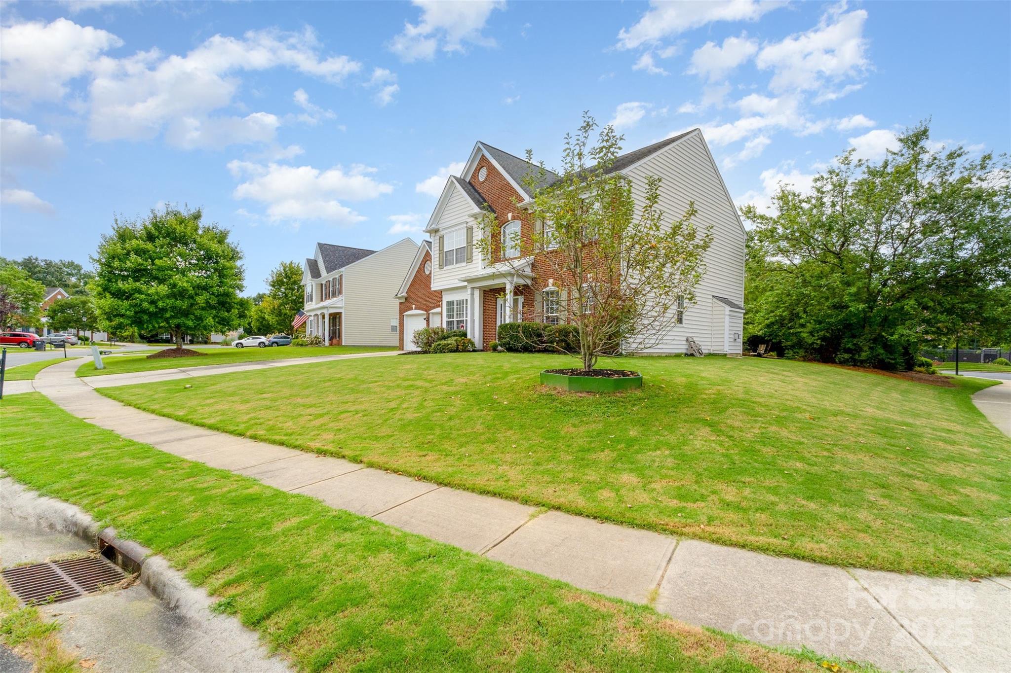7633 Rathburn Lane Charlotte, NC 28277 - Photo 25 of 27 a view of a big house with a big yard and potted plants