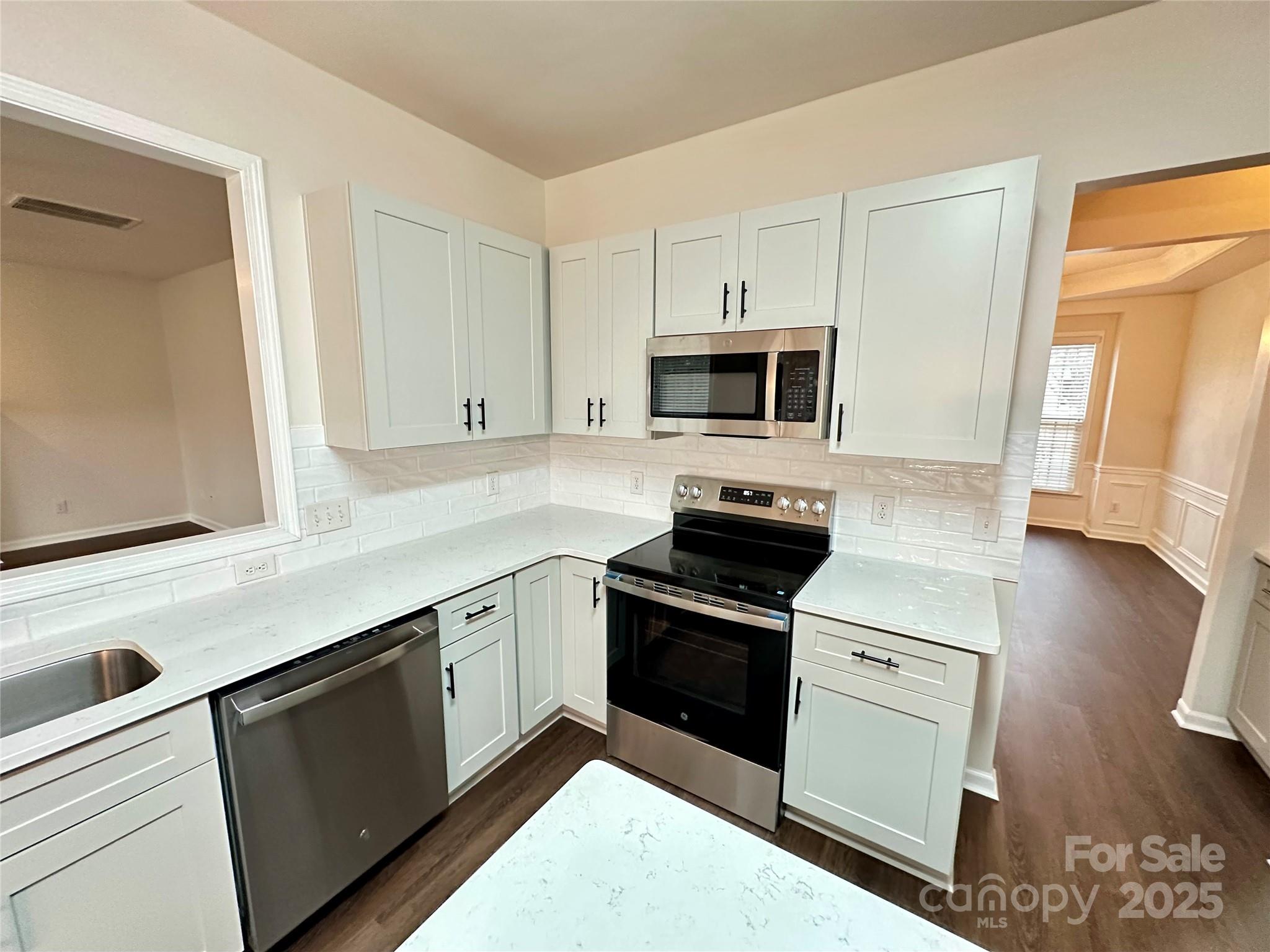 7633 Rathburn Lane Charlotte, NC 28277 - Photo 9 of 27 a kitchen with a sink stove and microwave